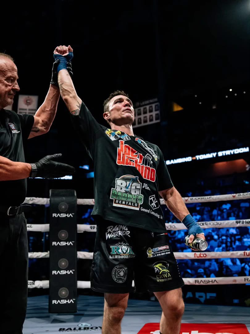 Referee raising Joey Gambino's hand after his win over Tommy Strydom