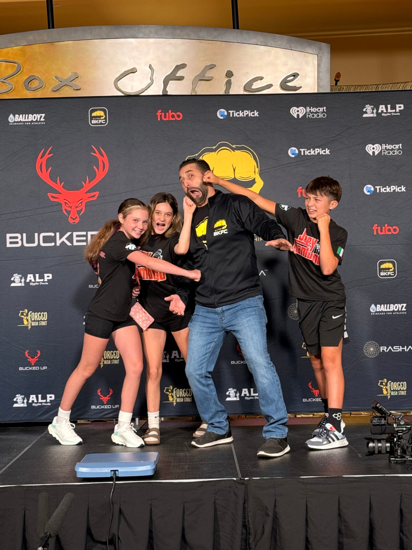 Joey Gambino posing playfully with his kids on the BKFC weigh-in stage