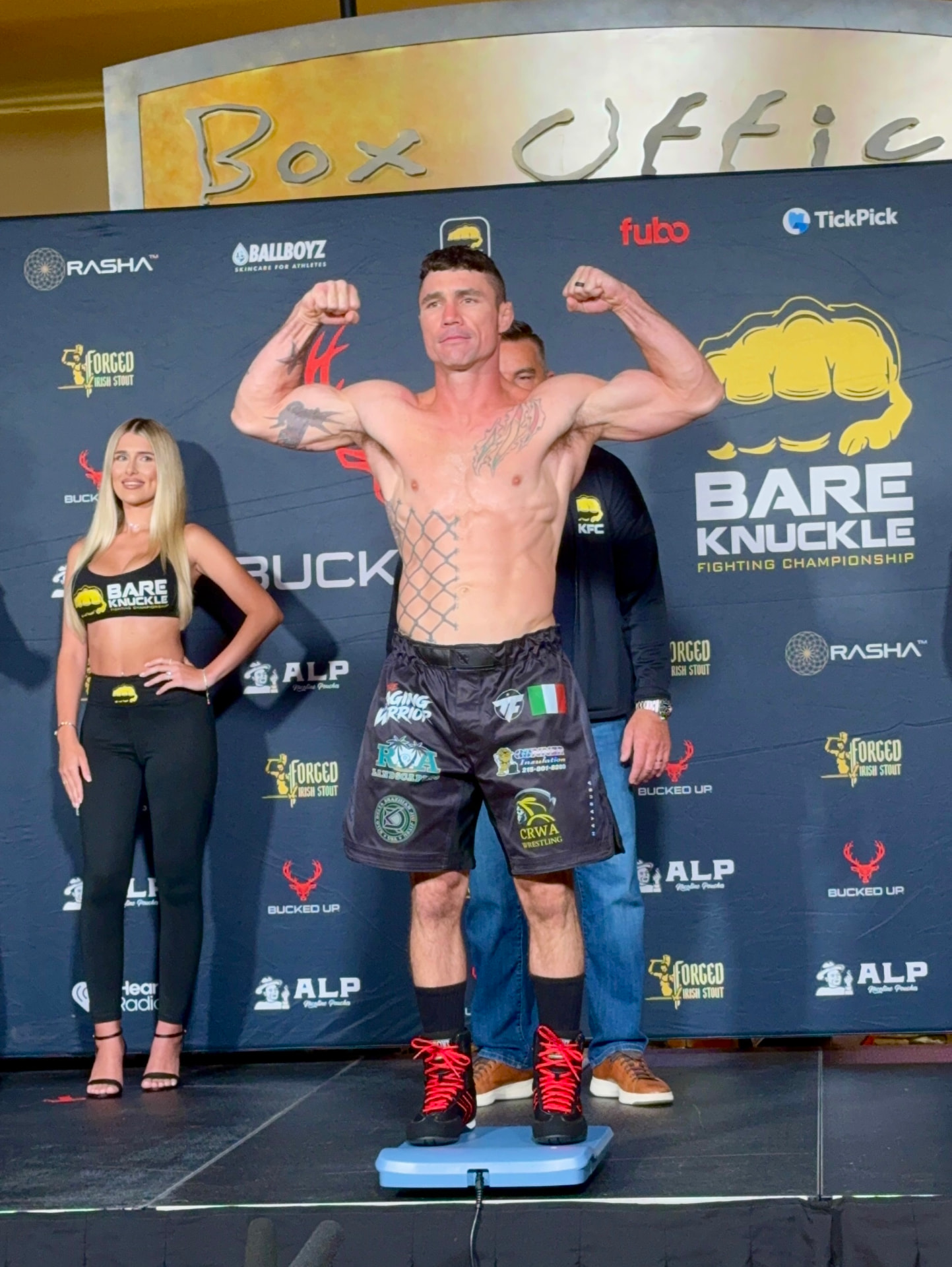 Joey Gambino flexing on the scale at the BKFC weigh-in